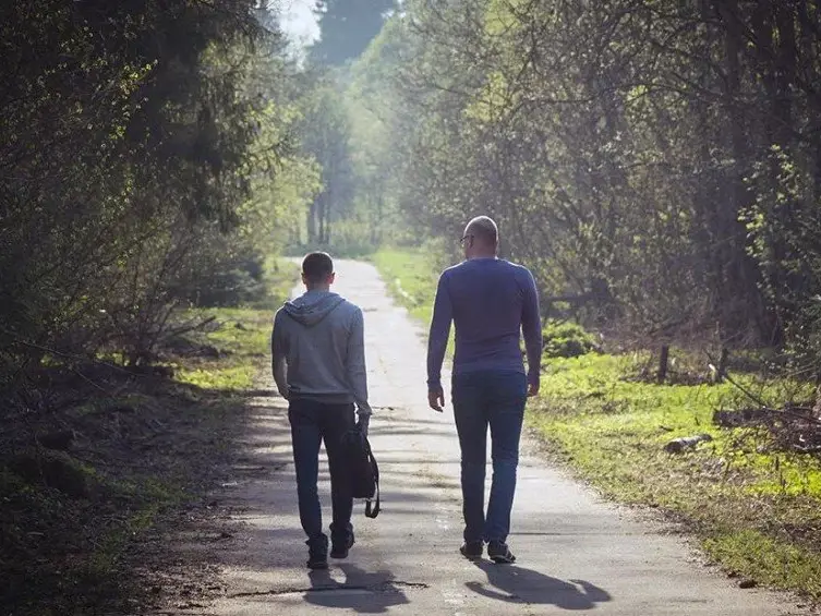 Two people walking side by side, reflecting the philosophy of walking beside someone at Keystone Lodge.