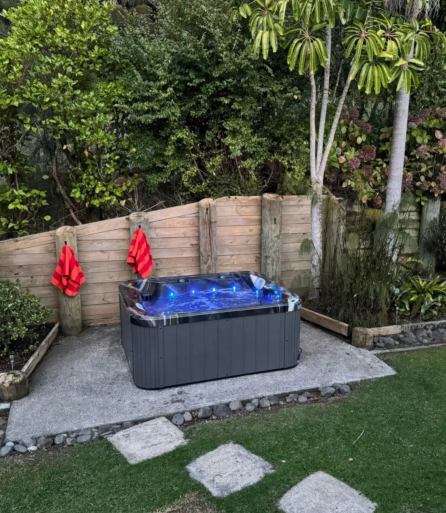 The outdoor spa pool at Keystone Lodge, lit blue on a concrete patio in the evening