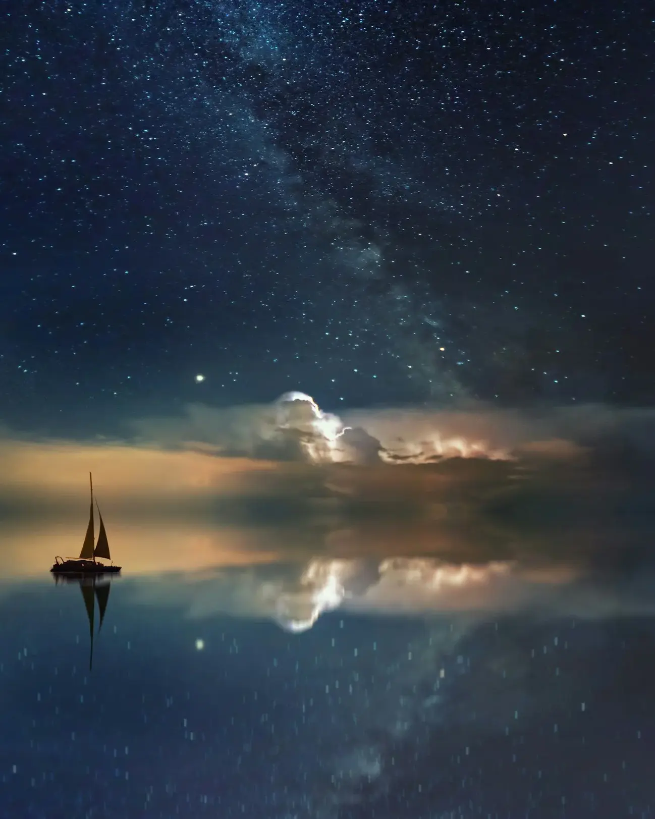 A boat on calm water with light breaking through storm clouds.