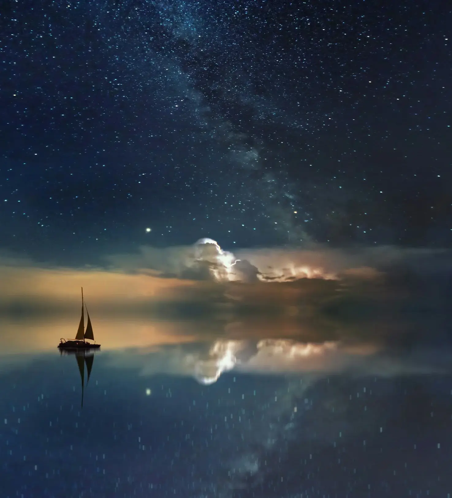 A boat on calm water with light breaking through storm clouds.