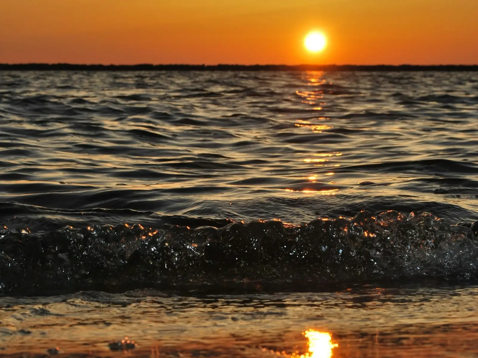 Sunset over the ocean. At the end of every day the sun goes down and rises again the next, one day at a time.