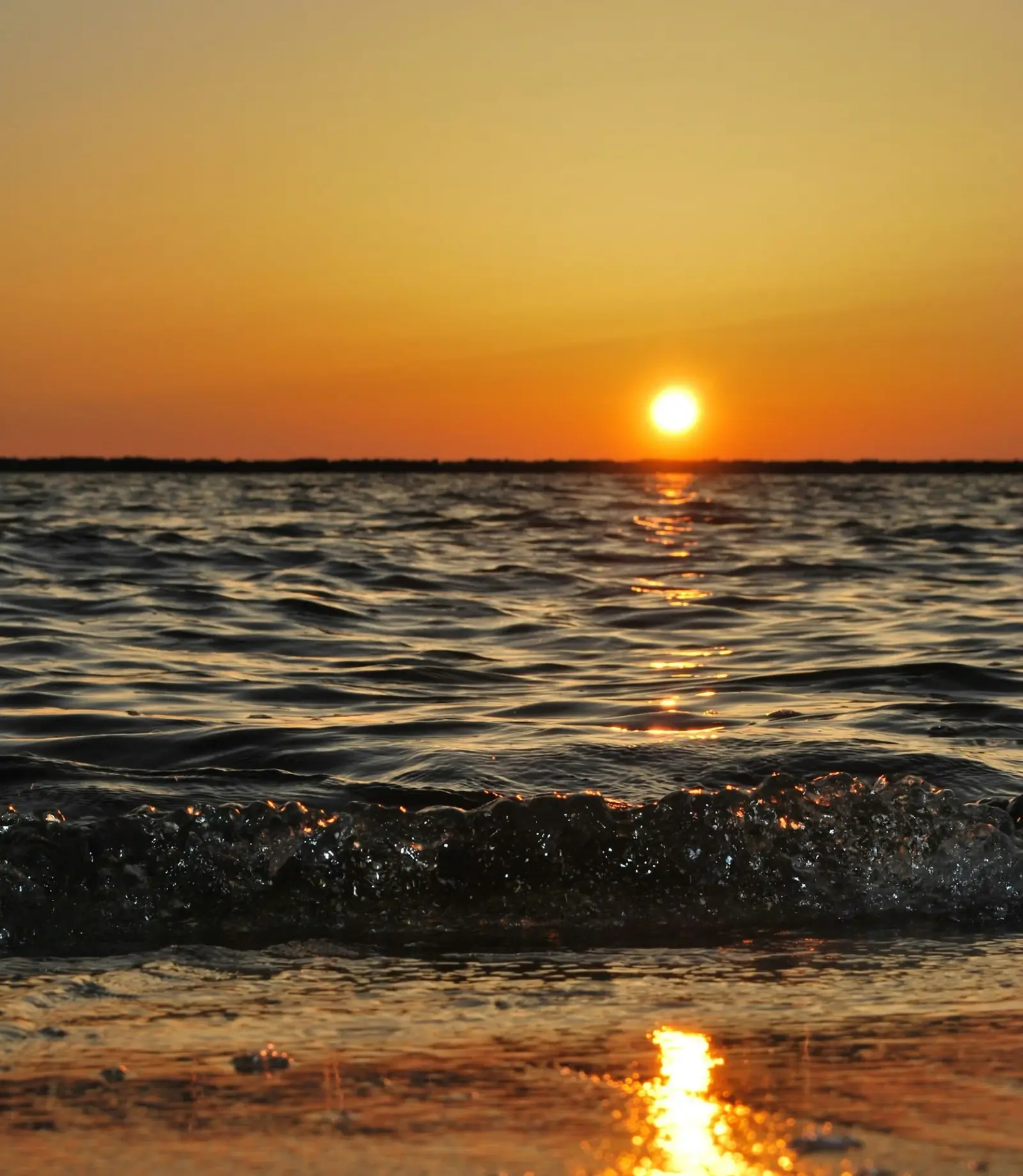 Sunset over the ocean. At the end of every day the sun goes down and rises again the next, one day at a time.